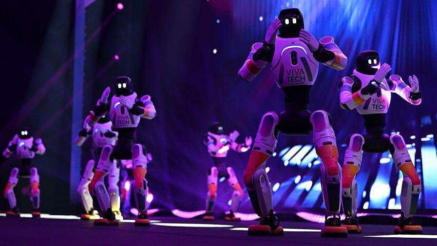 Agibot robots perform a routine on a stage at the VivaTech conference in Paris in 2026