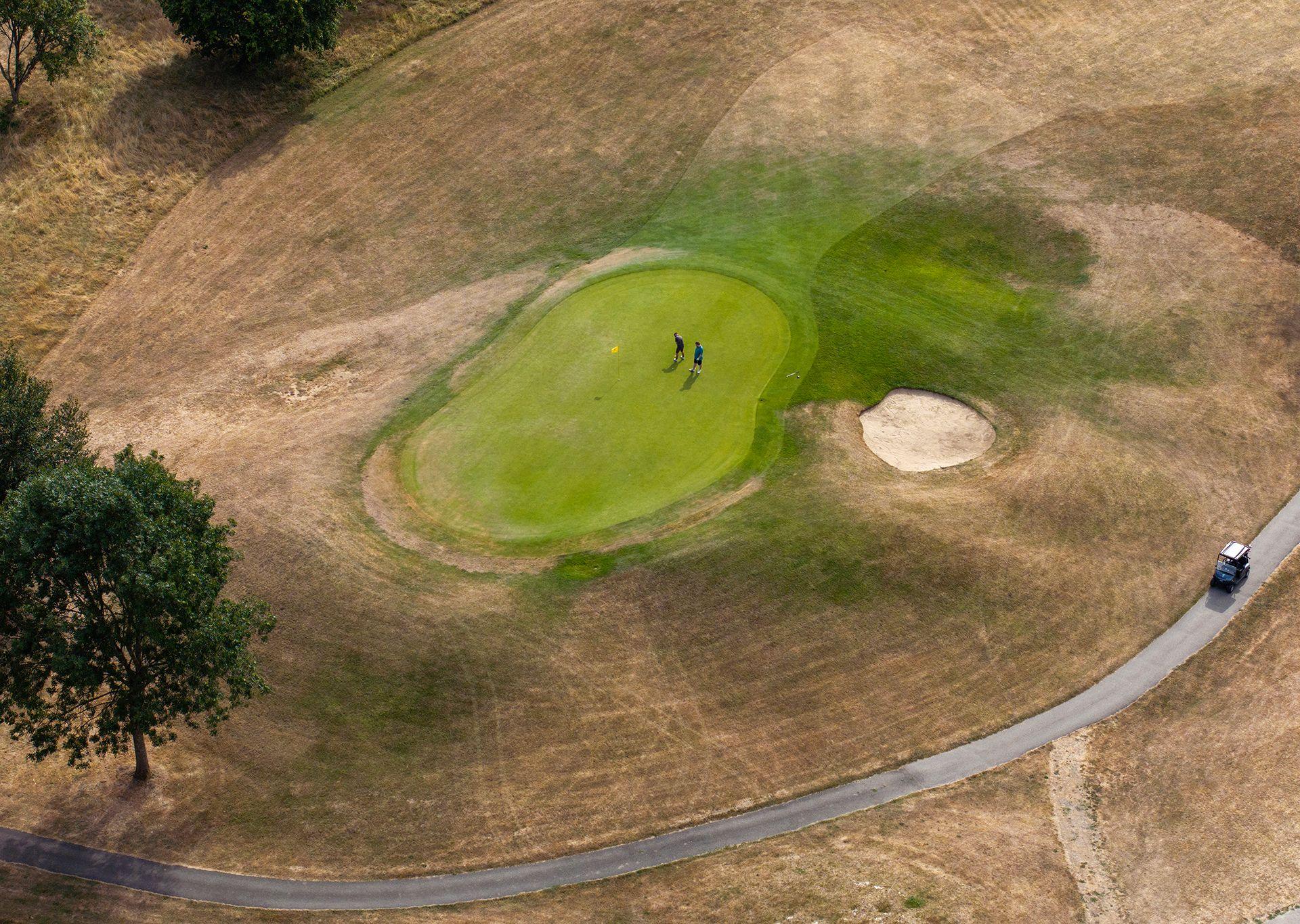 In this aerial view, golfers on the green at Woldingham Golf Club on July 25, 2026 in Woldingham, United Kingdom.