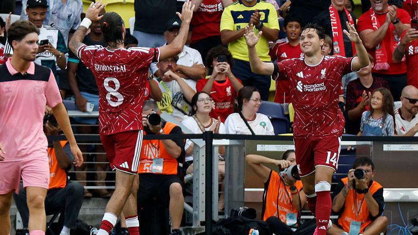 Liverpool players celebrate against Sunderland