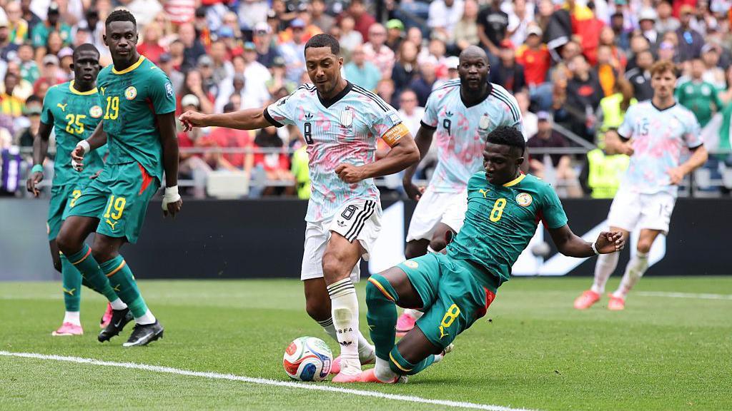 Belgium captain Youri Tielemans is fouled by Lamine Camara