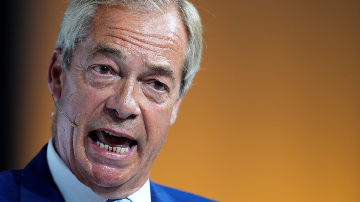 Reform UK leader Nigel Farage speaking during a conference at Olympia London in June 2026.