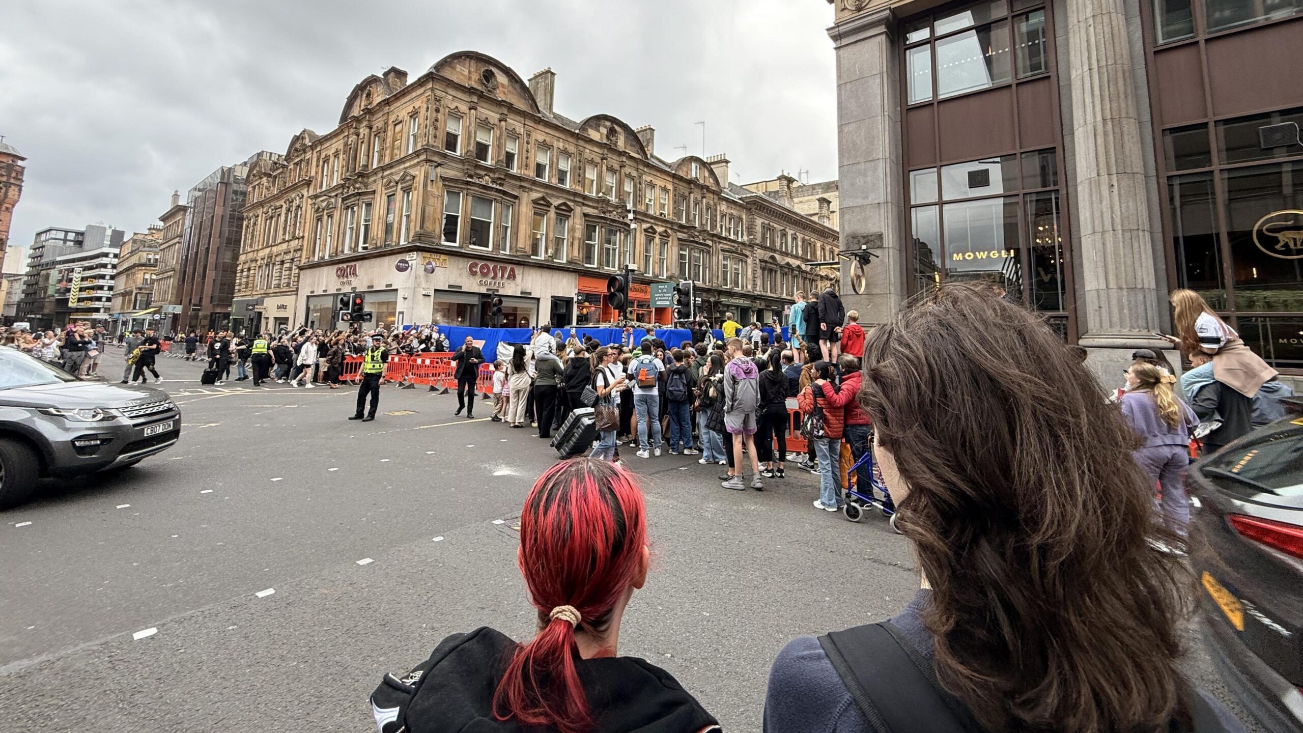 Crowds of people watch filming in the centre of Glasgow