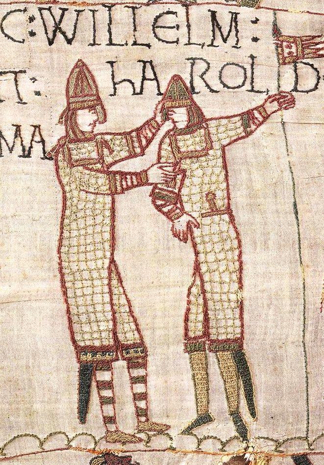 A close crop of the same scene, centred on William and Harold embracing, with writing saying 'Willelm' and 'Harold' with fabric texture detail.