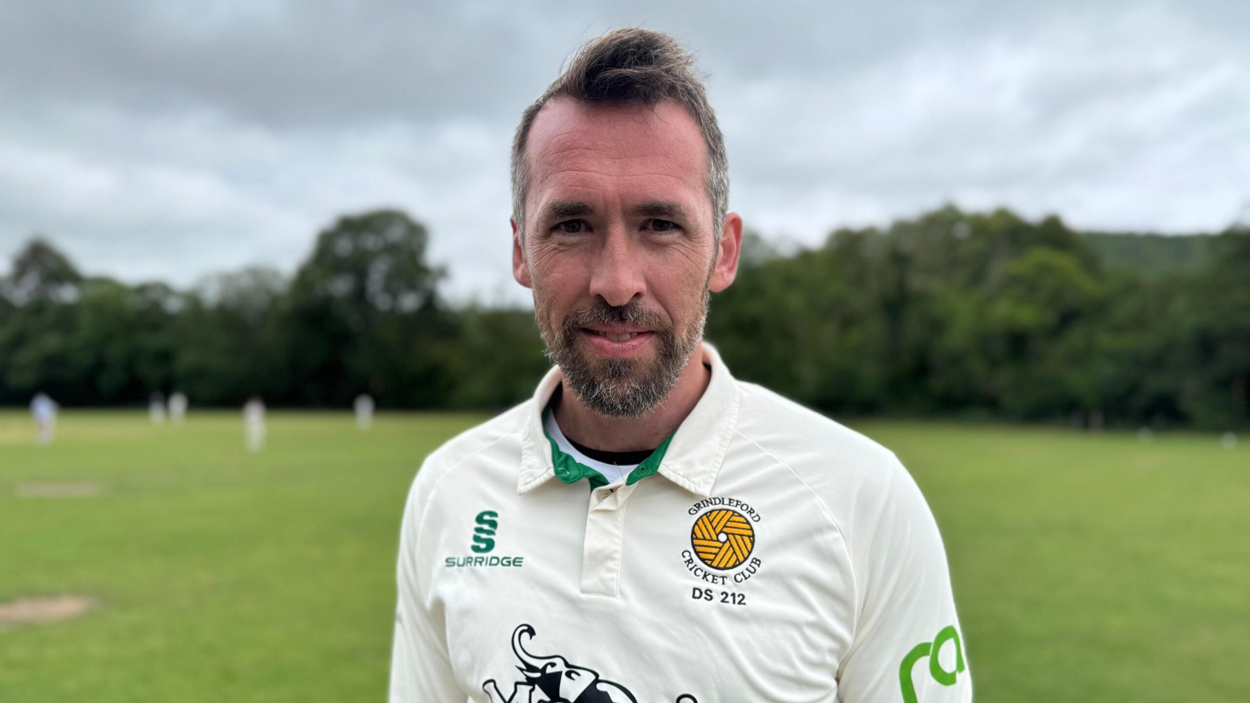 Christian Fuchs in his cricket whites by the his local village ground