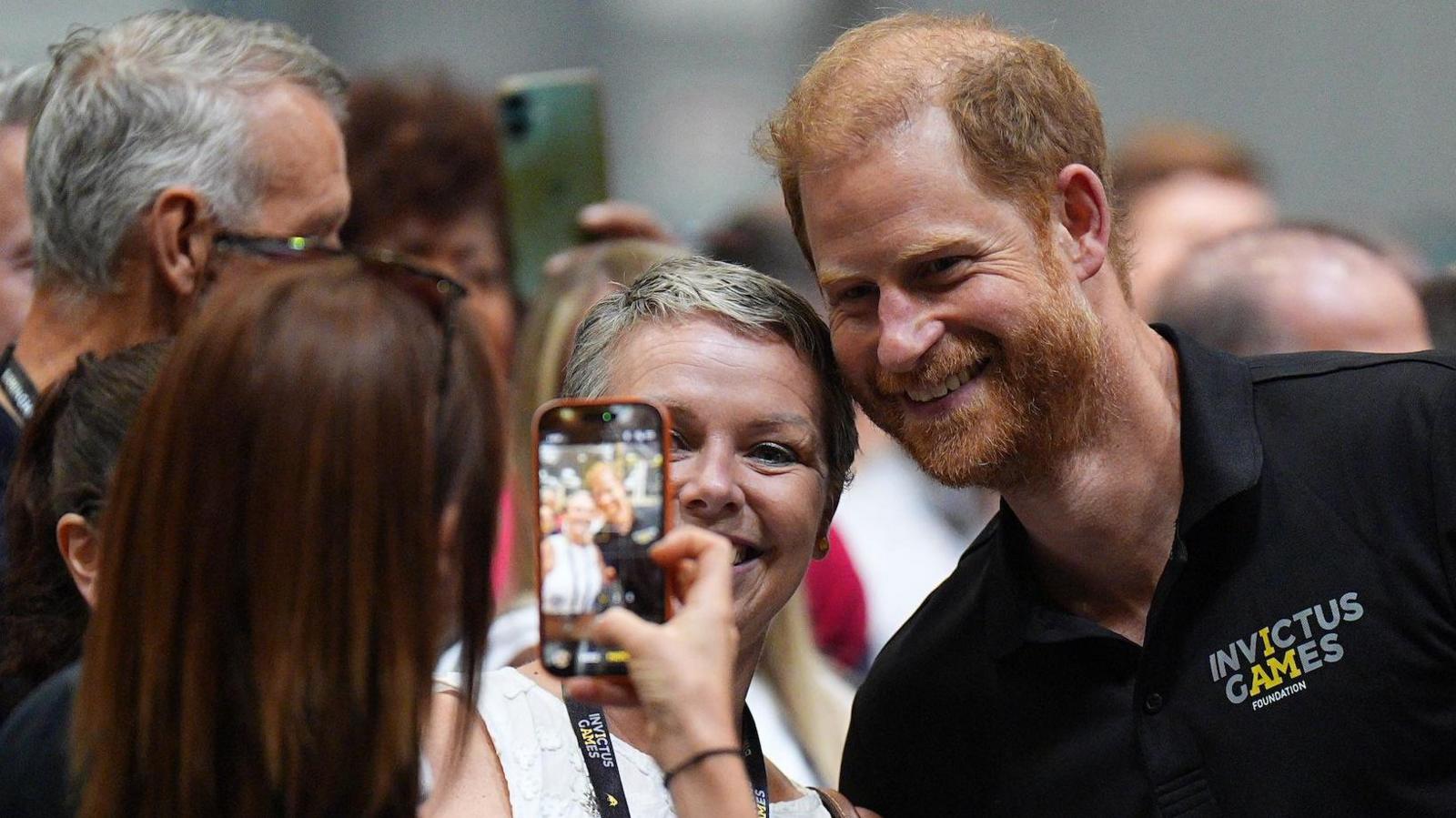 Prince Harry having a selfie taken with supporters of the Invictus Games in Birmingham