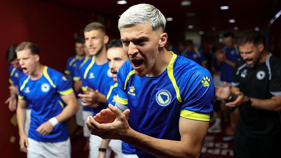 Tarik Muharemovic clapping his hands when walking out for Bosnia and Herzegovina