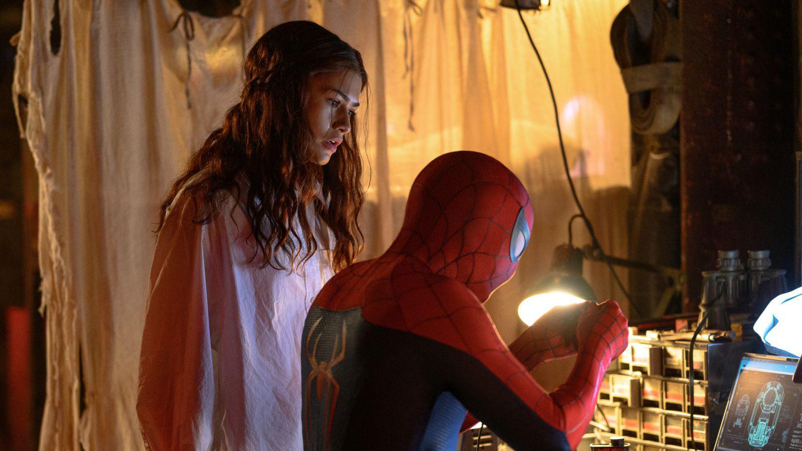 Zendaya as MJ watching Spider-Man, played by her husband Tom Holland, working with his hands while sat as a desk