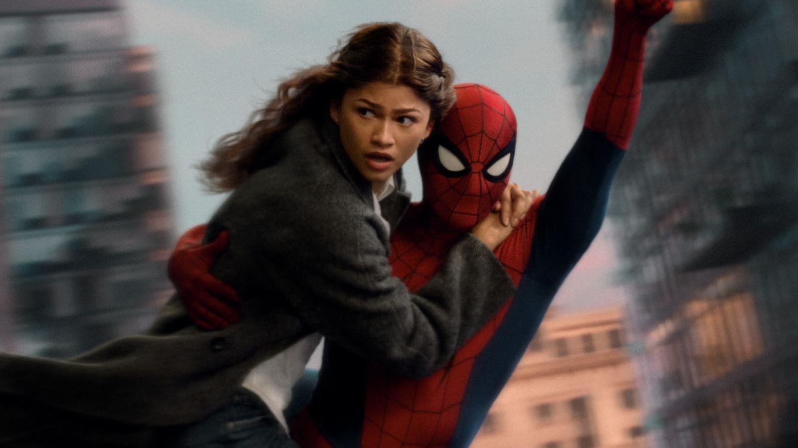 Zendaya as MJ holding on to Spider-Man, played by her husband Tom Holland, as they swing through the air