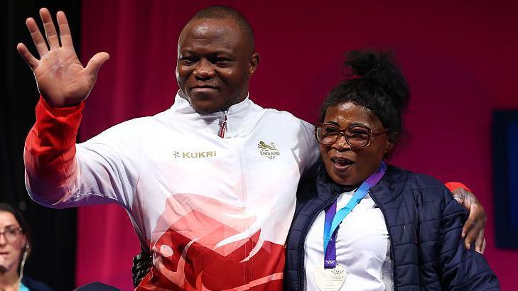 Silver medalist Cyrille Tchatchet II of Team England poses for a photo with family members