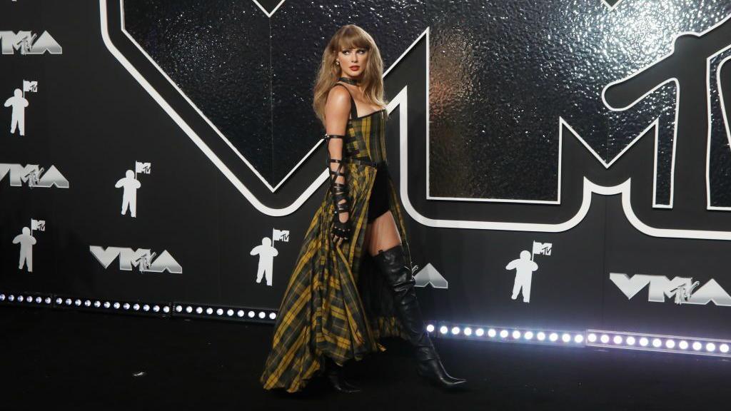 Taylor Swift wearing a yellow and green tartan dress at the MTV 2024 Video Music Awards