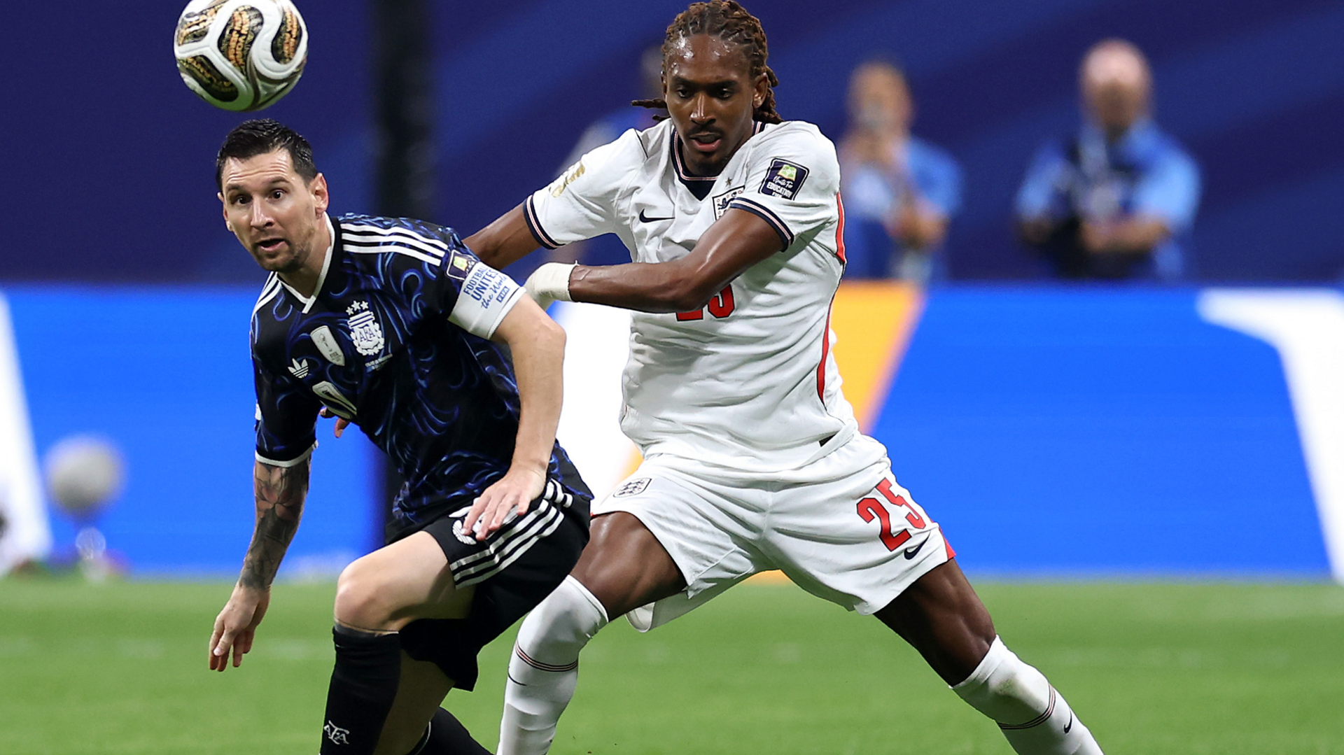 Lionel Messi and Djed Spence compete for the ball