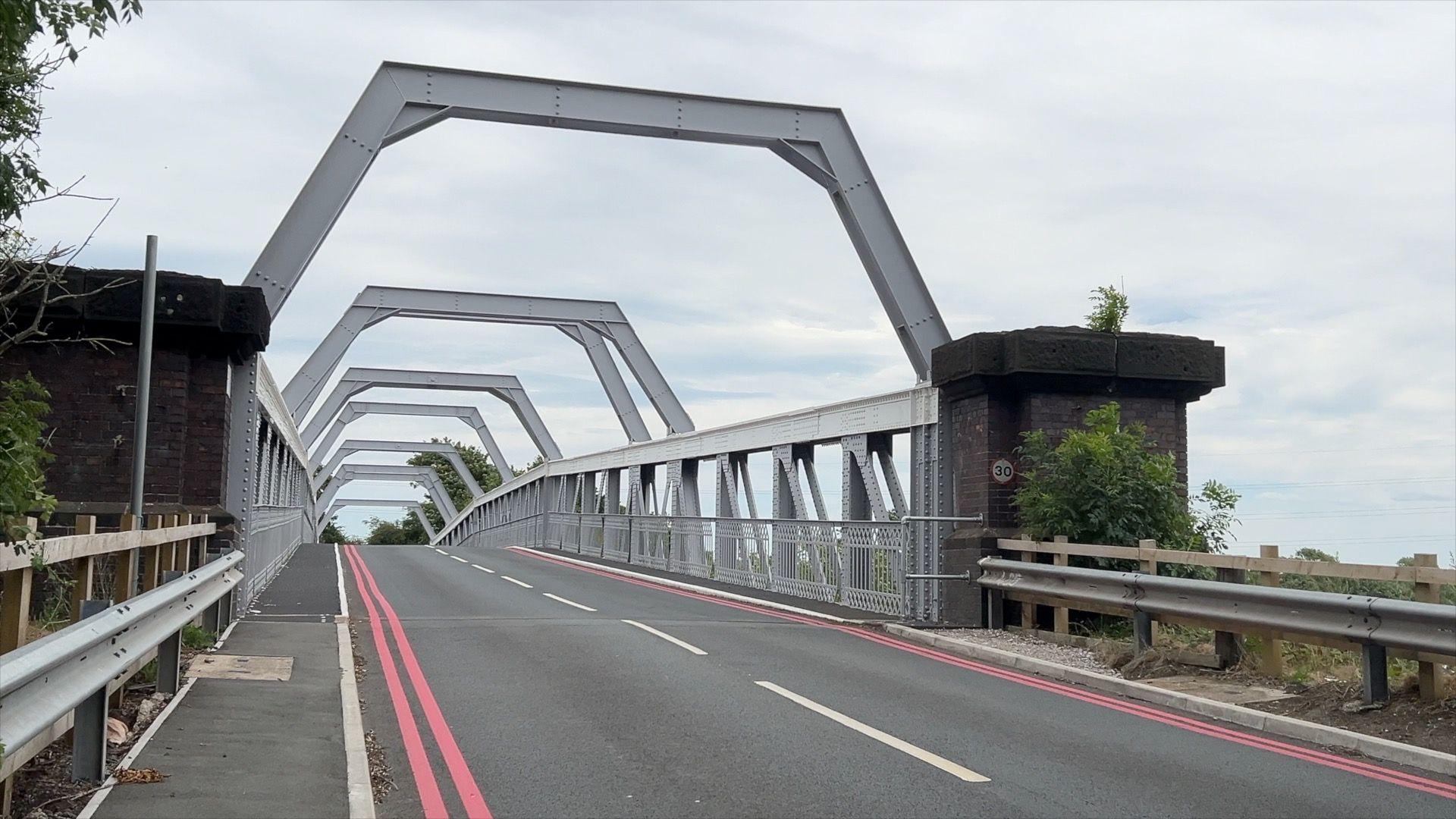 A view of the Warburton toll bridge. It is a metal framed bridge.