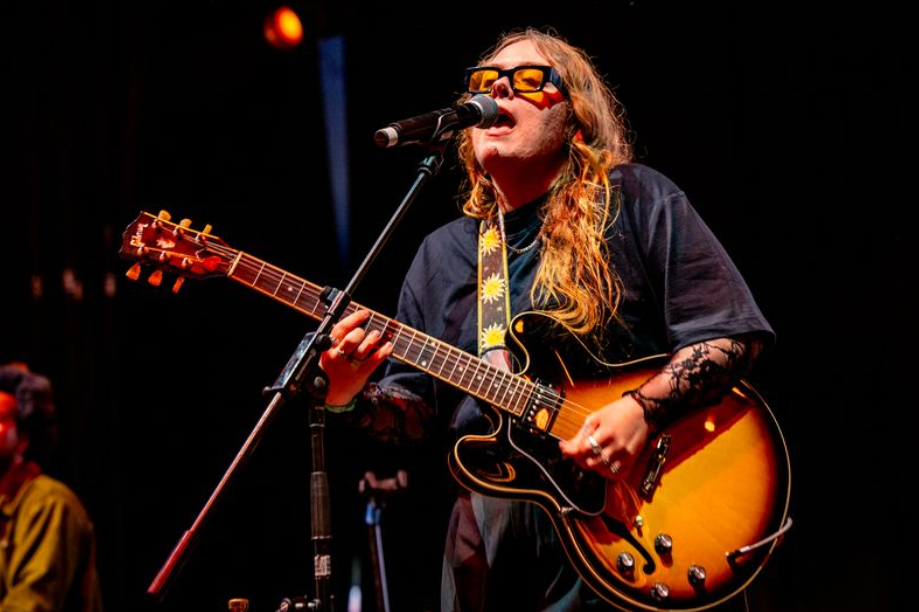 Woman on stage with a guitar