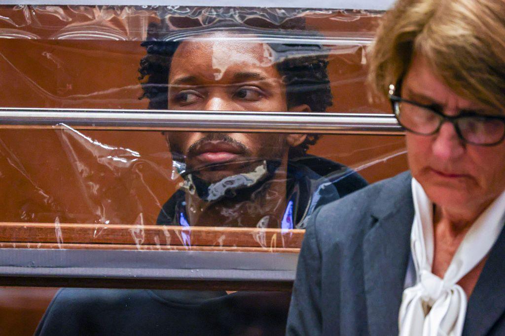 D4vd appears behind a clear plastic sheet in an LA courtroom during preliminary hearings into the murder charge he faces