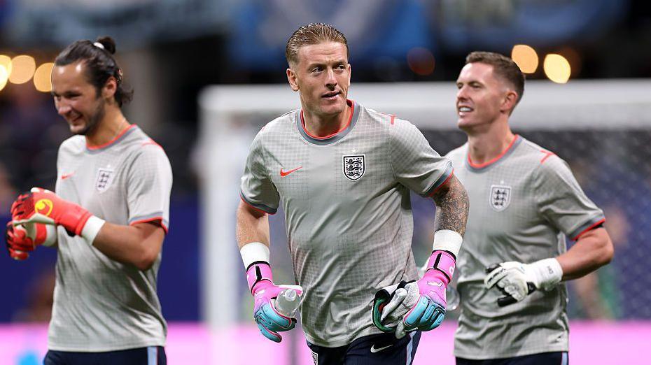 England goalkeeper rivals James Trafford, Jordan Pickford and Dean Henderson during a warm-up for England