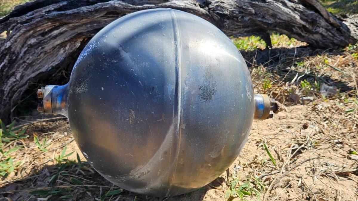 One of the six mysterious large silver spheres washed up on Forrest Beach in Queensland