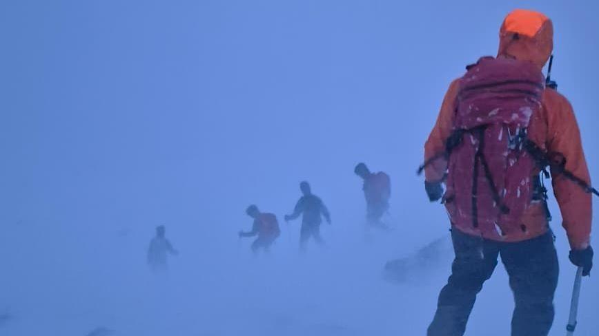 Rescuers in blizzard conditions.
