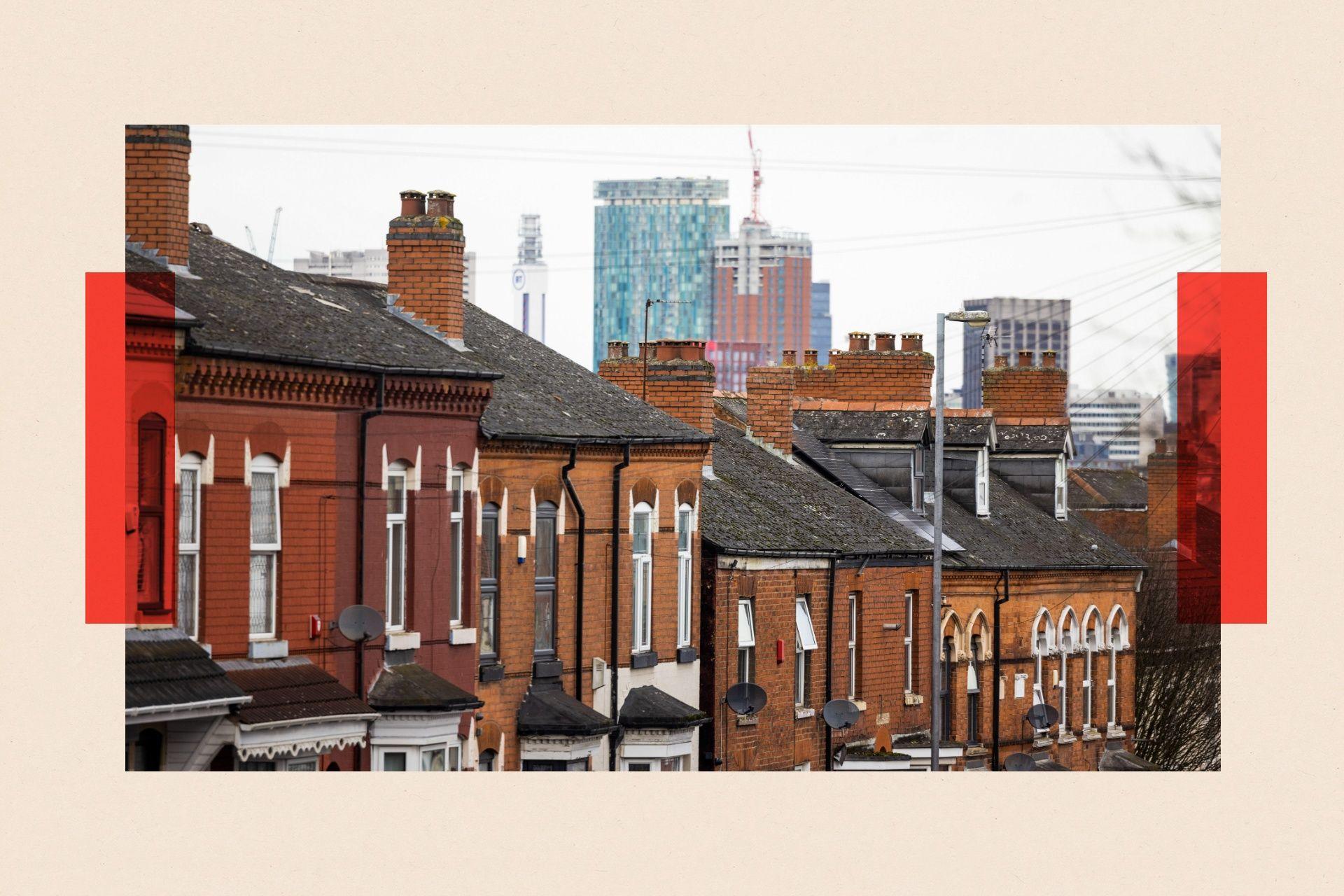 Residential properties, in red brick, against a backdrop of the city skyline in Birmingham