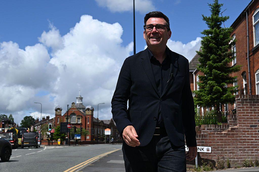 Andy Burnham walks down a street in Makerfield, Manchester
