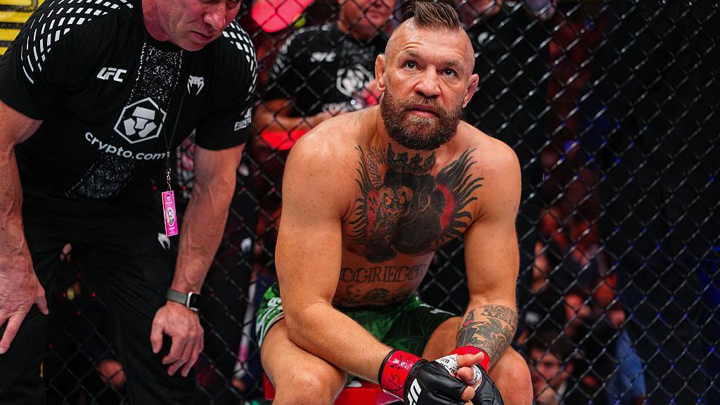 Conor McGregor sits on a stool