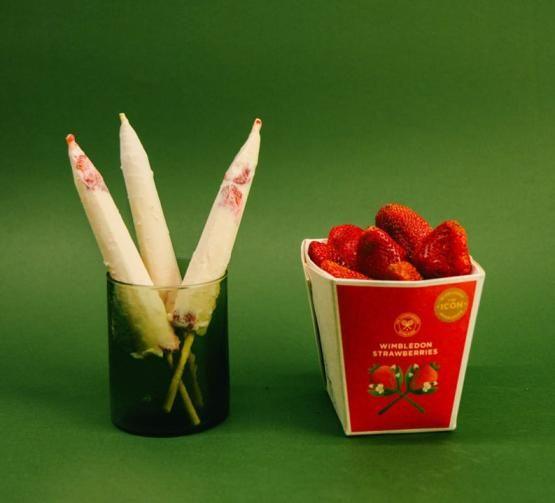 A strawberries and cream kulfi pictured alongside a carton of wimbledon strawberries in a KUReMAL'S promotional image.