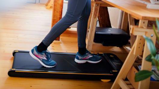File photo: someone in blue and pink trainers using a walk pad