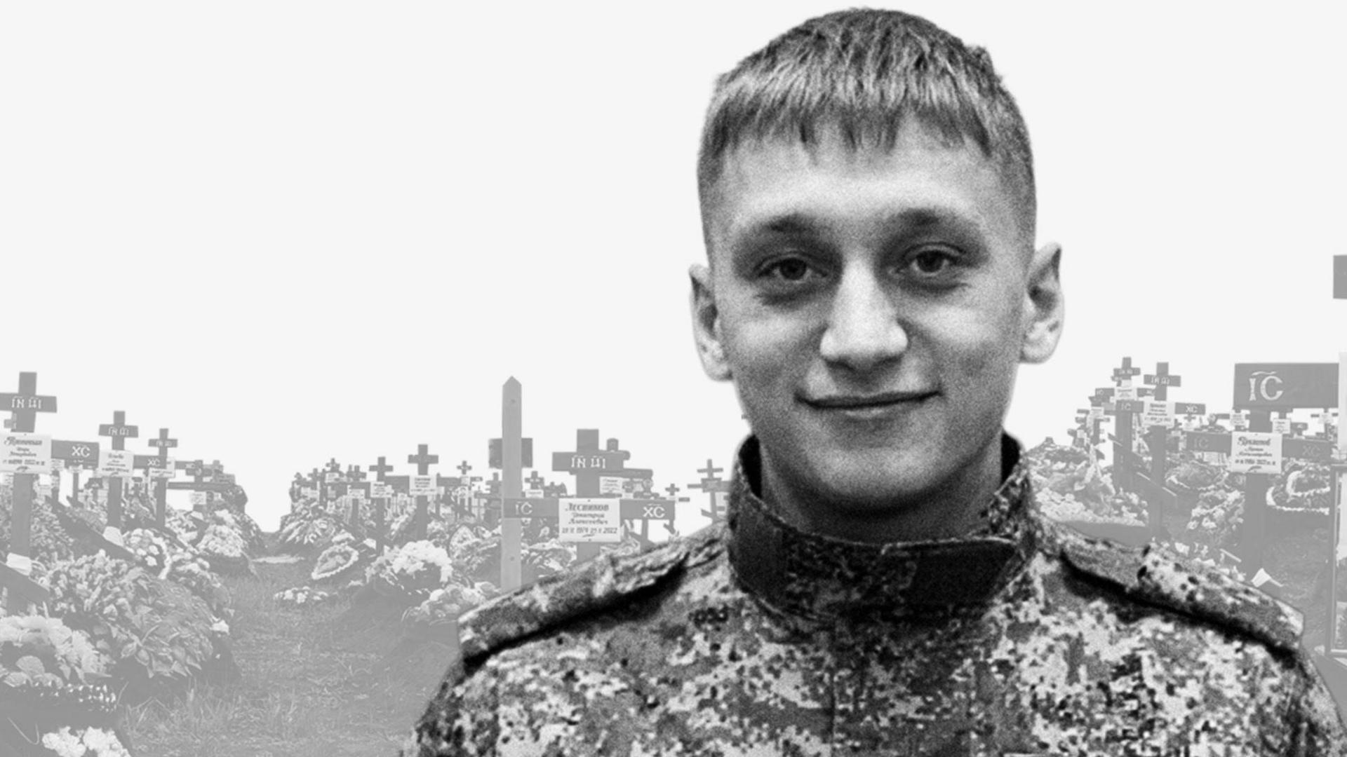 Valery Averin in uniform stands in front of an image of a cemetery