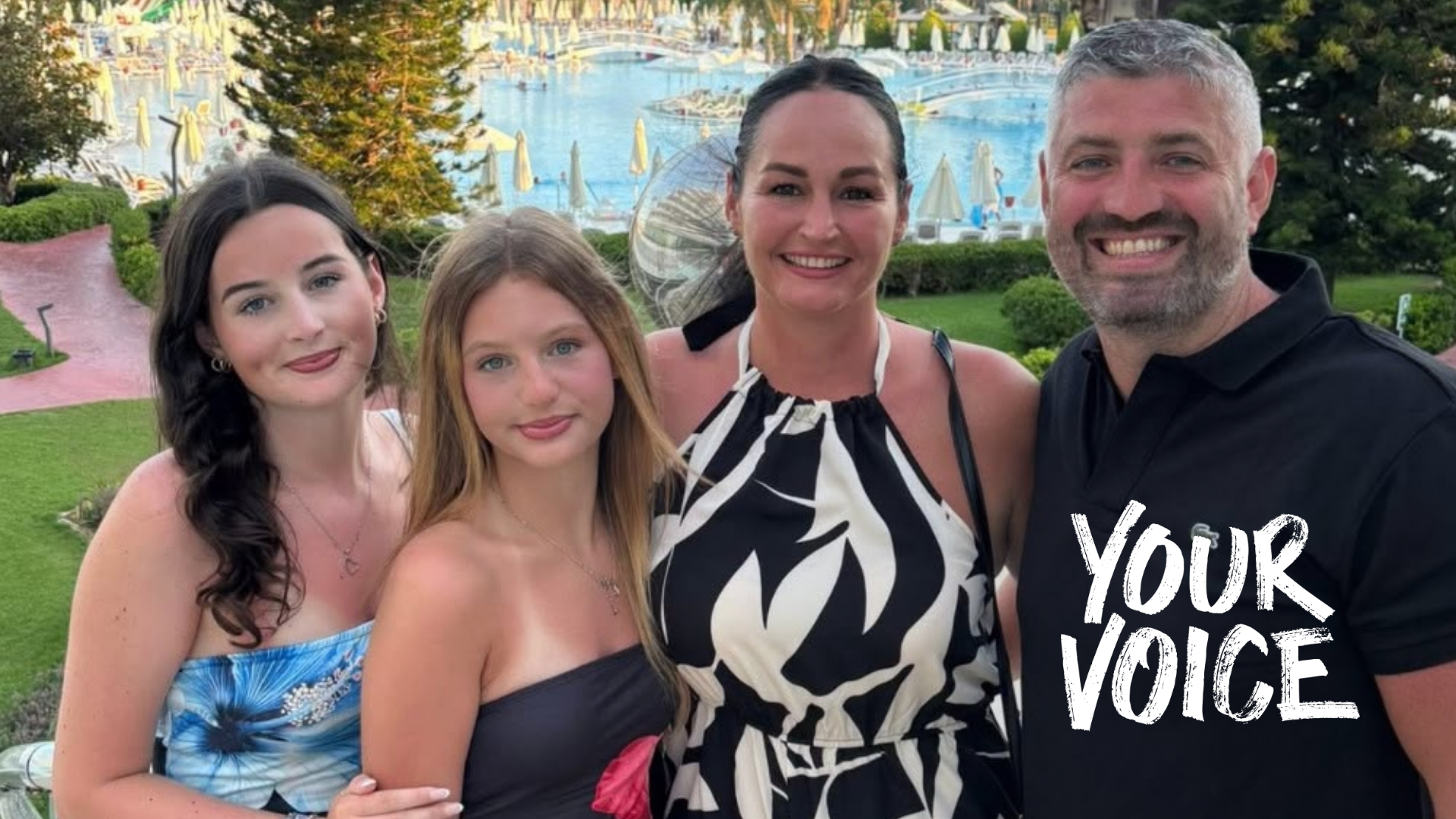 Tim Harris stands smiling with his wife Natalie and two teenage daughters on holiday, with a huge swimming pool in the background. The girls are wearing floral strapless tops, his wife a black and white print halter dress, and Tim is wearing a black polo short.