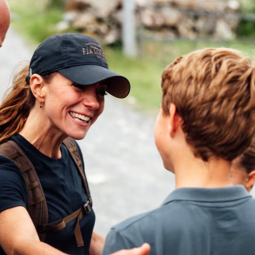Kate smiles at George who has his back to the camera as William looks on