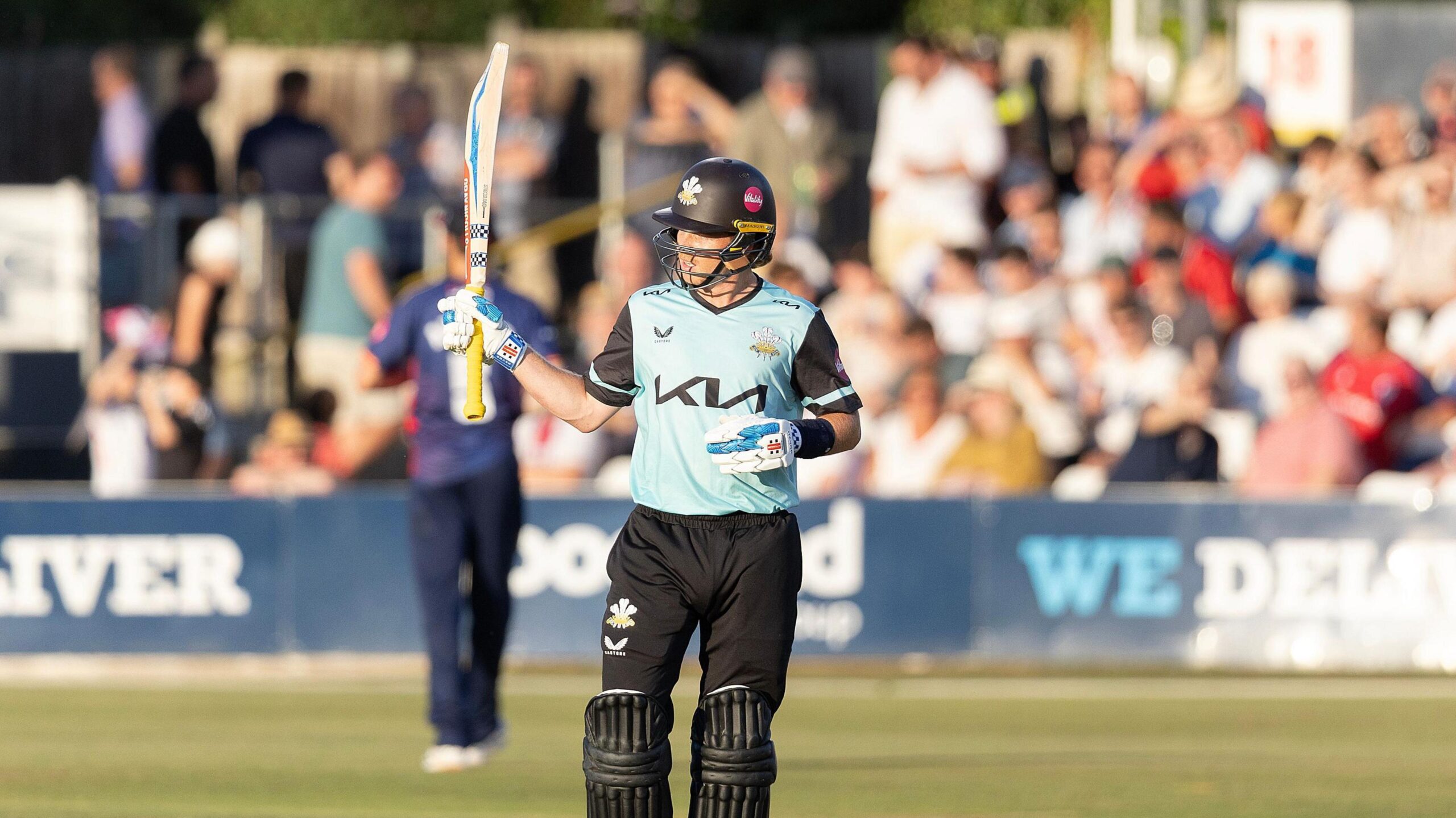 Surrey batter Ollie Pope holding his bat after scoring a half-century against Essex