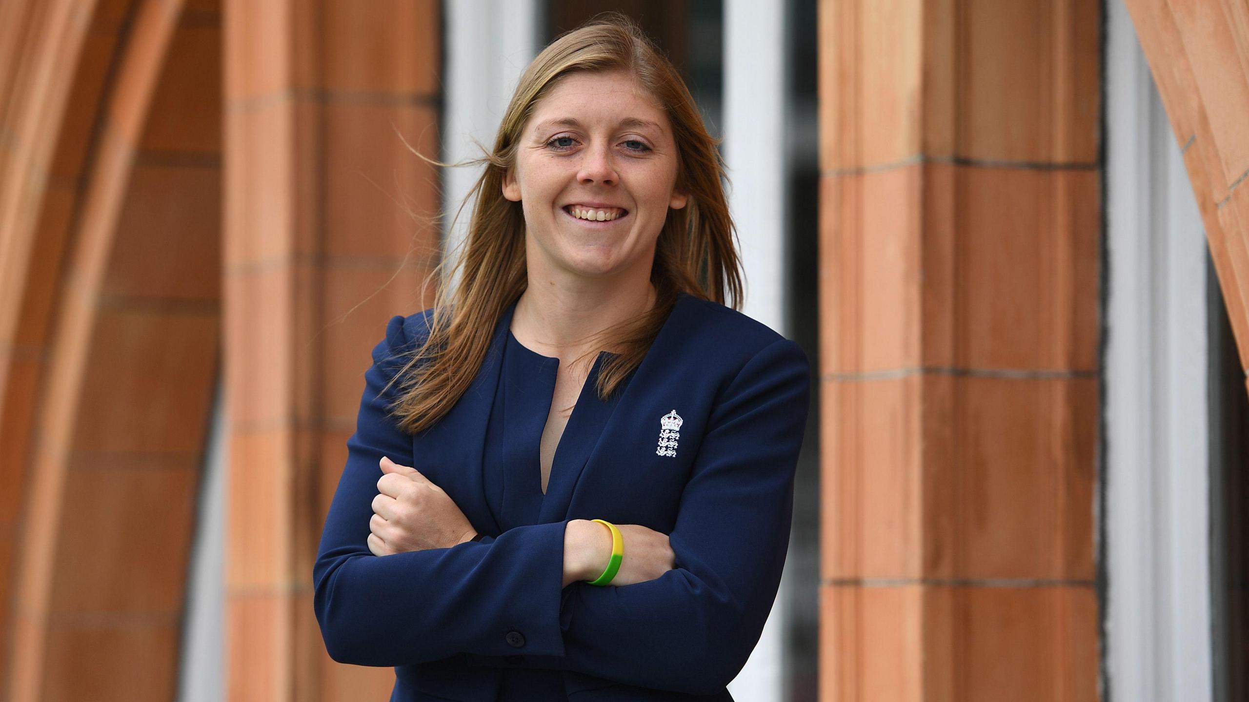 Heather Knight in a jacket posing at Lord's