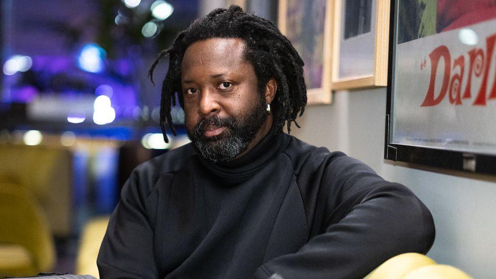 Marlon James during the BFI Presents Get Millie Black TV preview at BFI Southbank on February 18, 2025 in London, England.  has a beard and is wearing a black sweater.