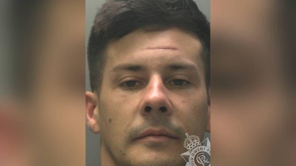 Mugshot of Owen Pendree. He is clean shaven and has short dark hair.