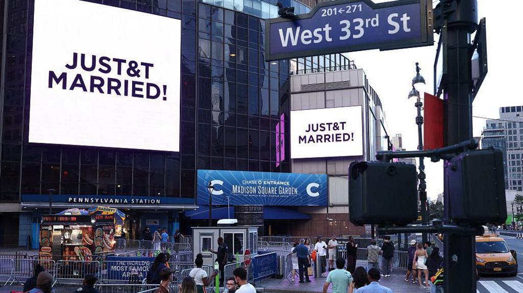 A giant screen shows the message "JUST&T MARRIED!" (T&T for Taylor and Travis) outside Madison Square Garden, the reported venue for the wedding celebrations of pop singer Taylor Swift and pro-athlete Travis Kelce
