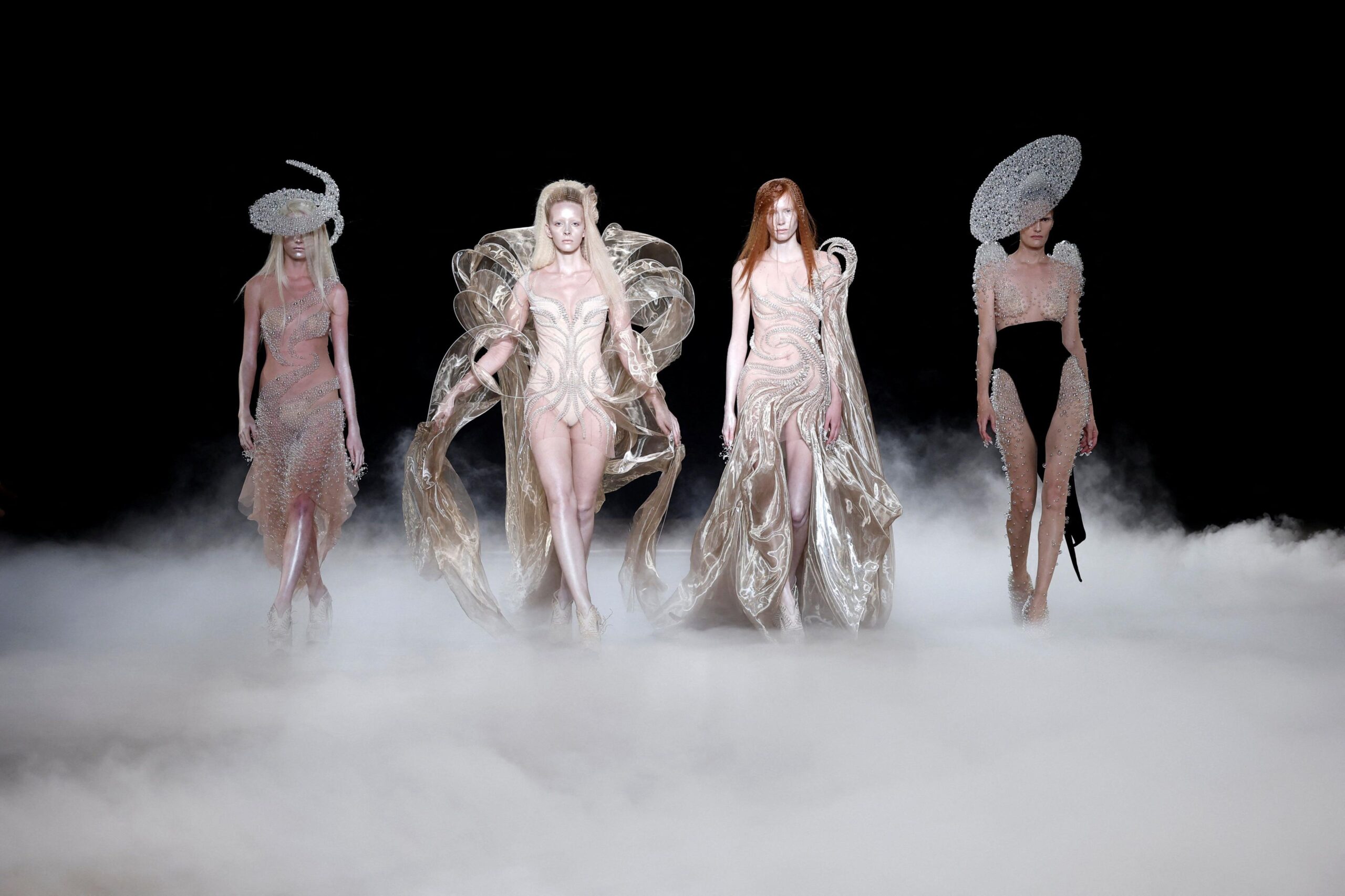 Models present creations by designer Iris van Herpen as part of her Haute Couture Fall/Winter 2026-2027 collection show in Paris, France, July 6, 2026.