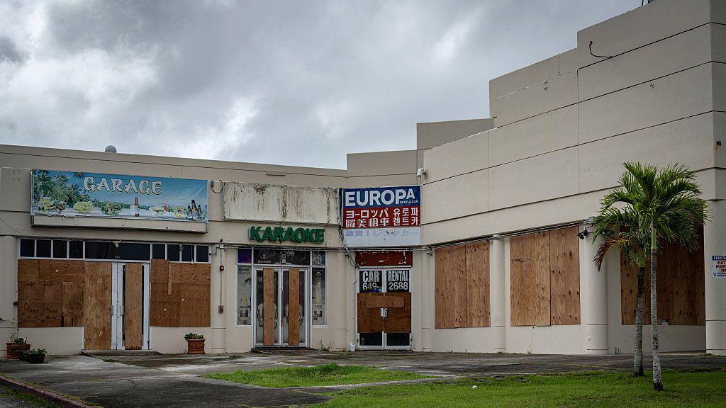 Stores boarded up with plywood are seen as the forecasted Super Typhoon Bavi approaches in Guam