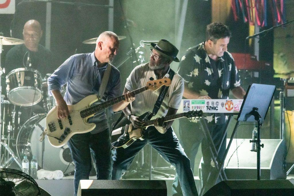 Bassist Horace Panter can be seen playing a white-bodied bass, with guitarist Lynval Golding seen on stage next to him. Terry Hall can also be seen on stage playing keyboards.