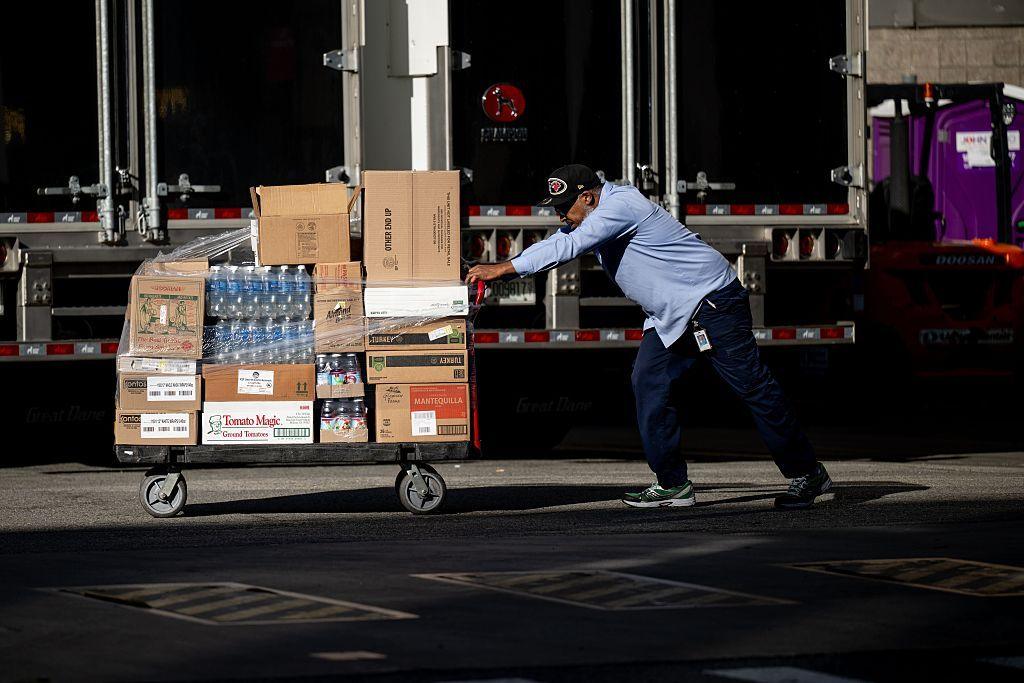A worker pushes pallets of water bottles and other items into Madison Square Garden on Thursday.
