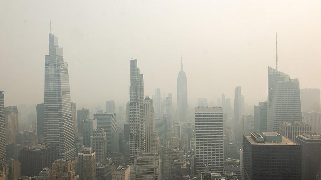 The New York City skyline is seen with a thick haze of smoke