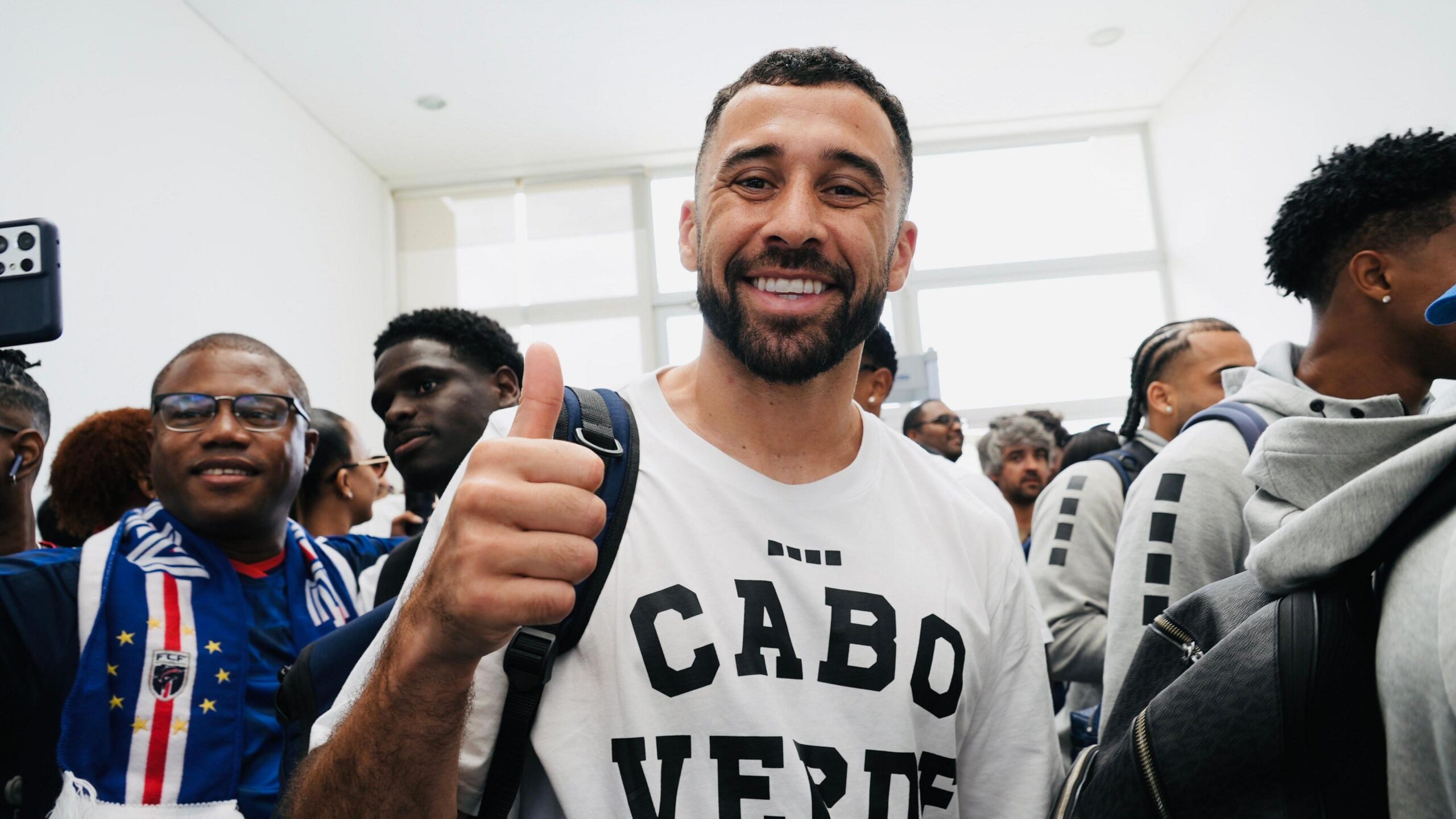 Pico Lopes smiles at the camera, wearing a white t-shirt emblazoned with the words "Cabo Verde"