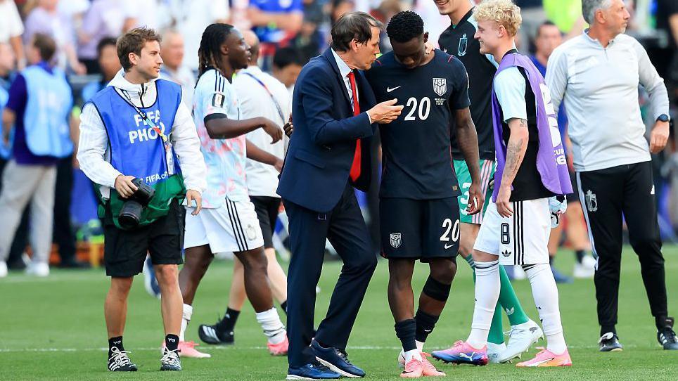 Balogun talks to the Belgium boss Rudi Garcia  after the match