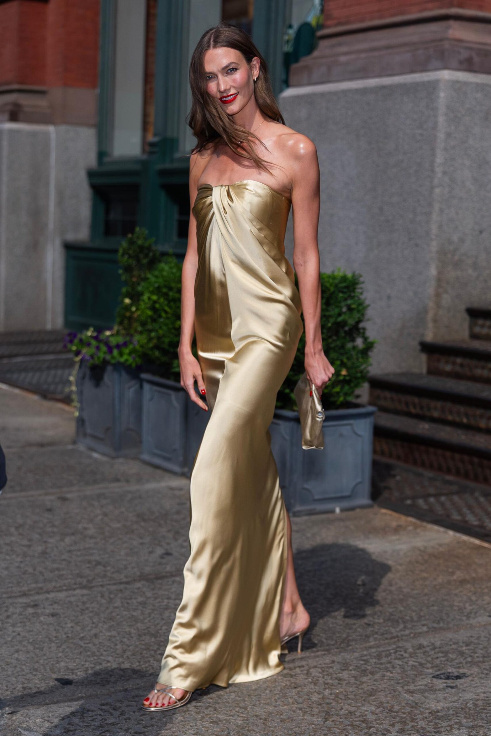 Karlie Kloss in a long strapless gold dress