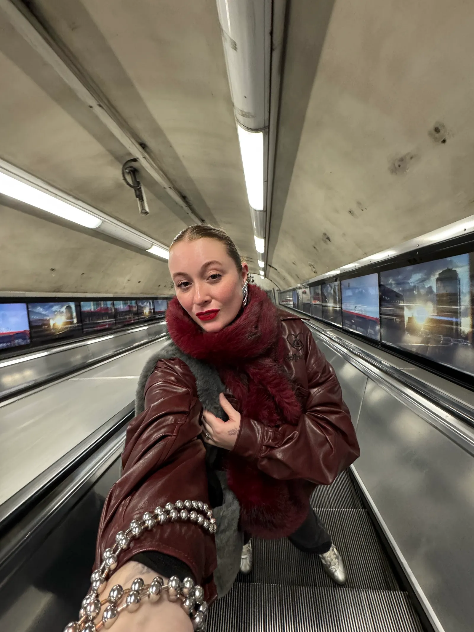 Image may contain Adult Person Clothing Coat Jacket Terminal Head Face Photography Portrait Sitting and Railway