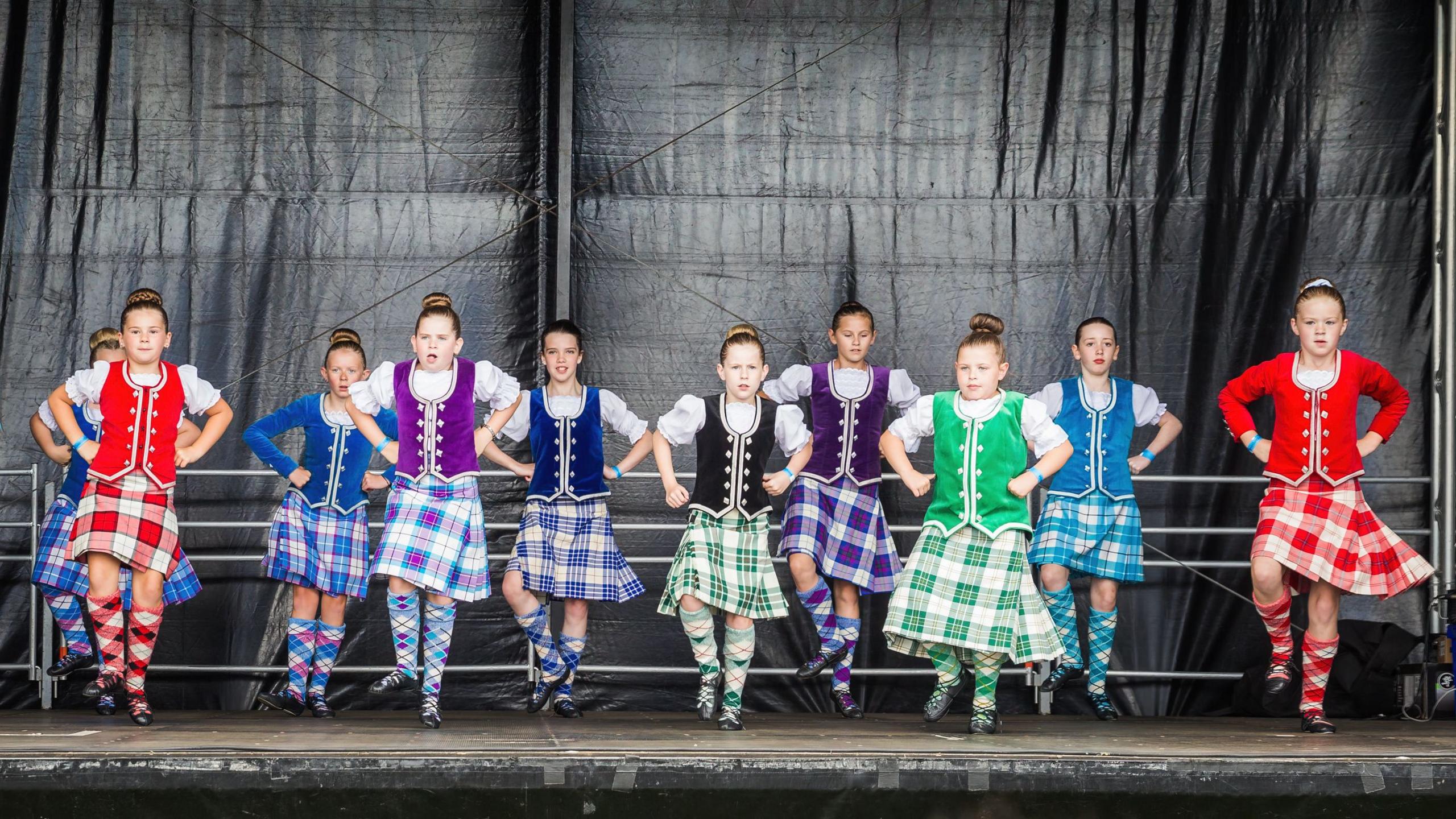 A troop of young Scottish dancers in colourful traditional dress