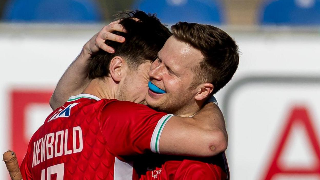 Jack Pritchard and Fred Newbold celebrate a goal against Scotland