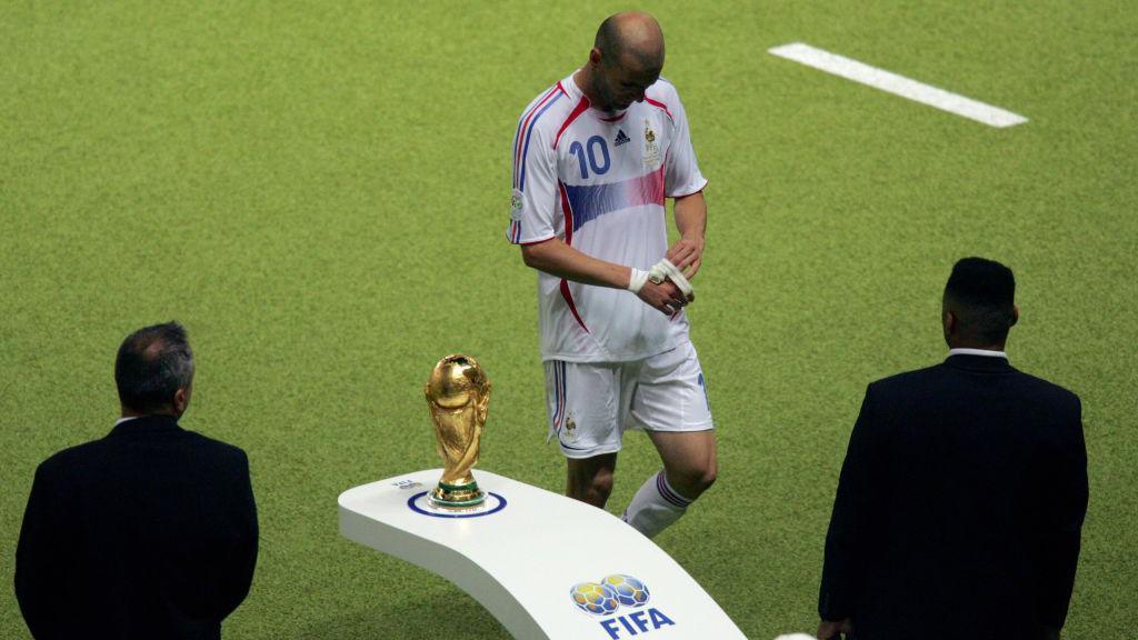 Zinedine Zidane walks past the World Cup trophy after being sent off against Italy