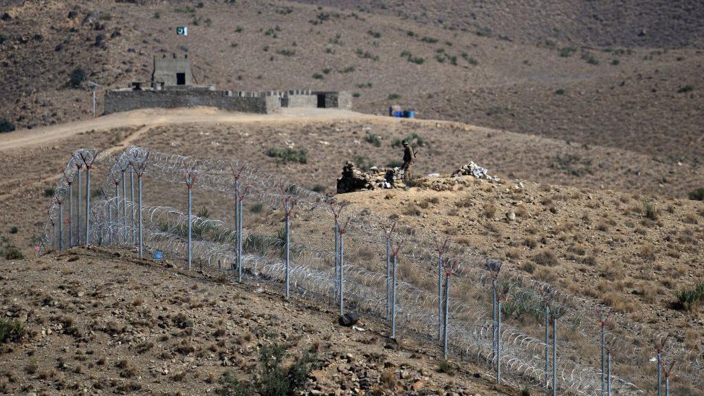 File photo of a Pakistani soldier standing beside a barb-wire fencing in North Waziristan, along Pakistan's border with Afghanistan