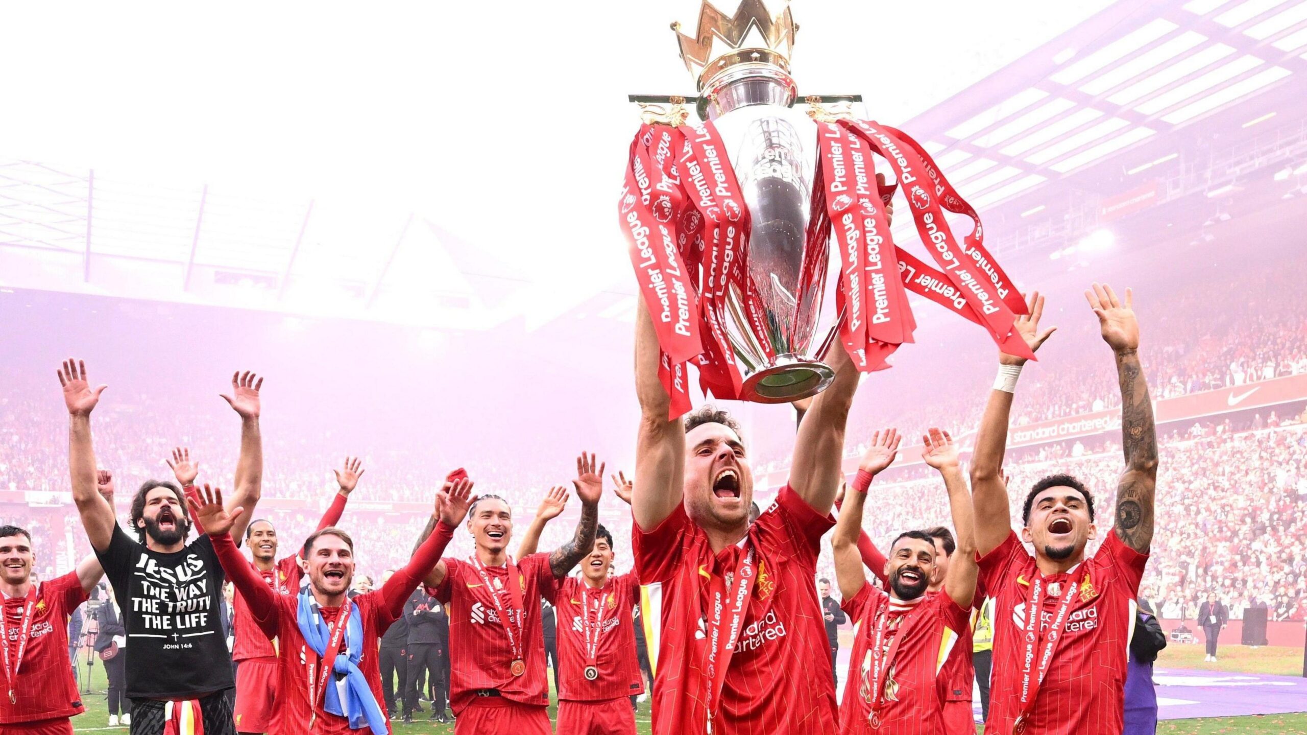 Liverpool's Diogo Jota celebrates with the Premier League trophy in front of The Kop at Anfield