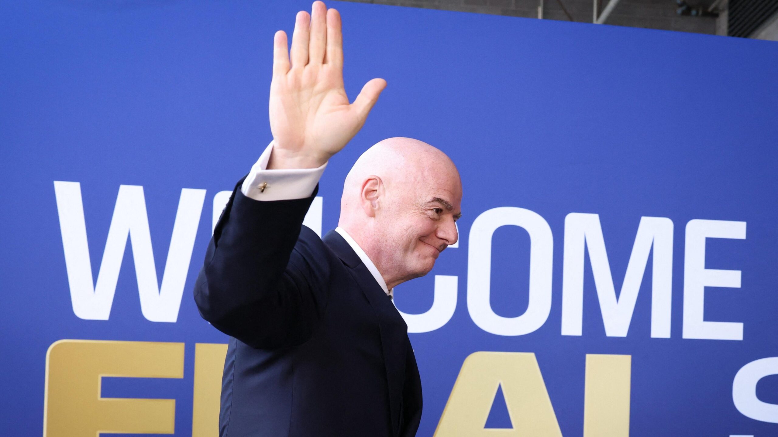 Fifa president Gianni Infantino waves while walking