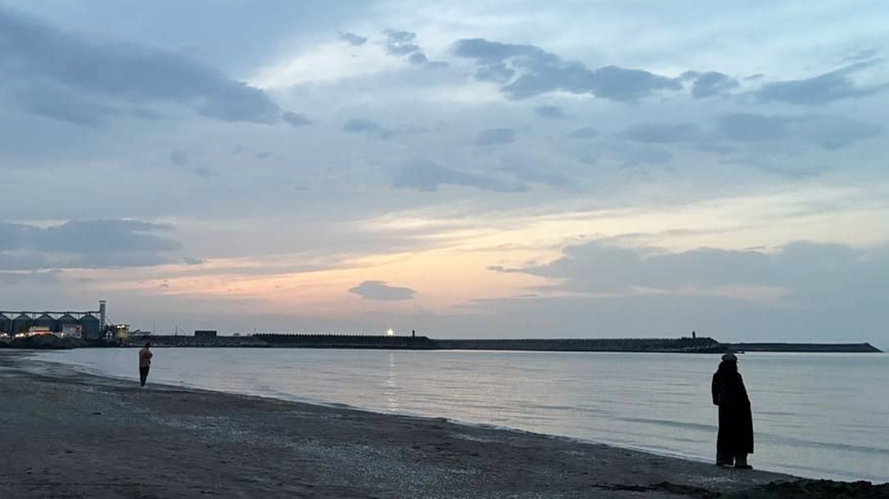 A woman stands on a Caspian Sea beach in Iran. File photo